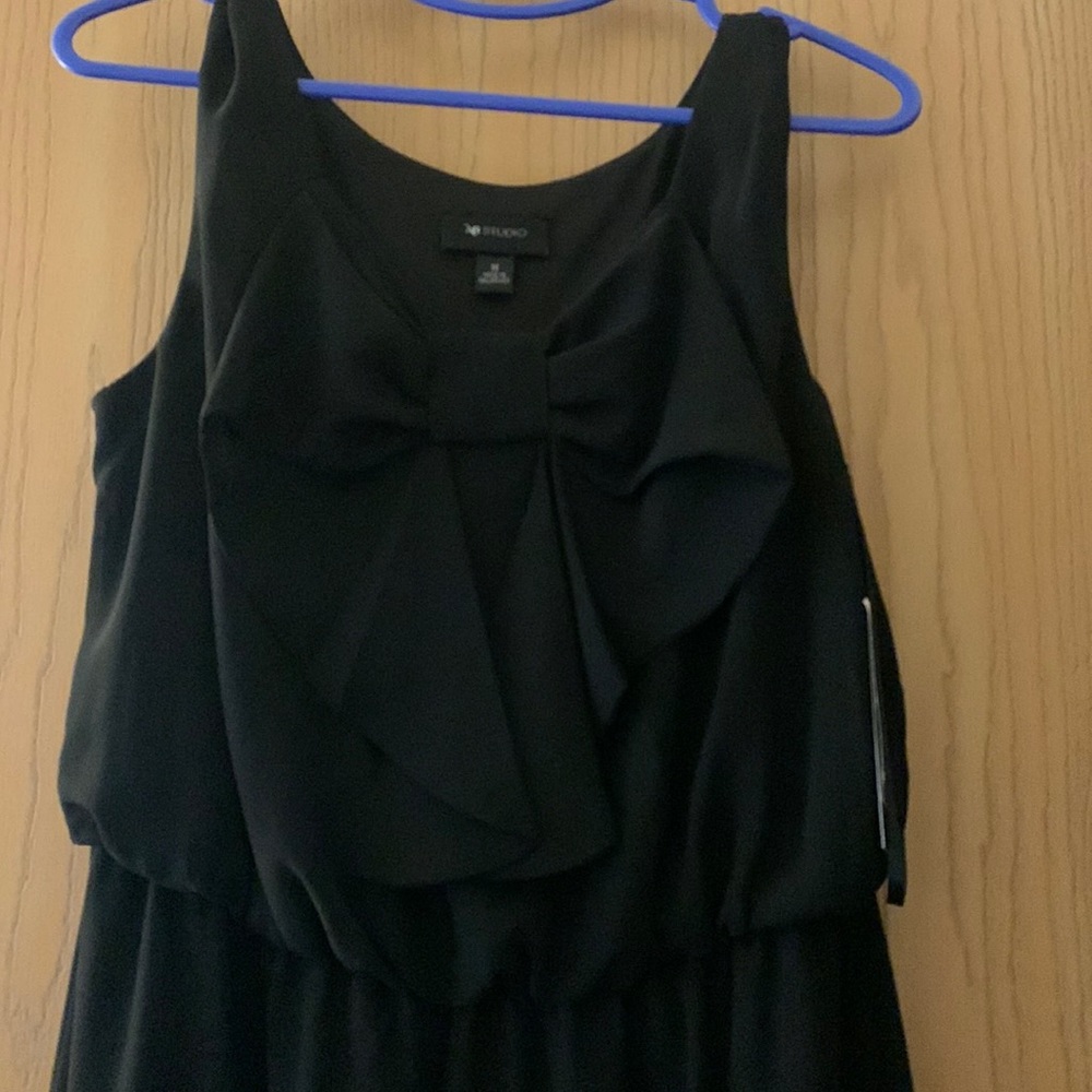 Sleeveless black dress.